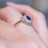Antique Belle Époque sapphire and diamond cluster engagement ring showing elevated ornate setting.