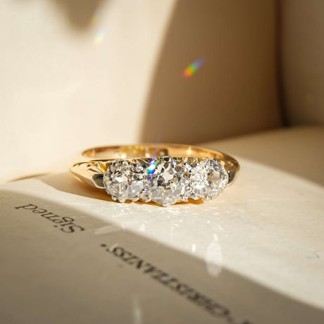 antique diamond three stone engagement ring with victorian style in yellow gold