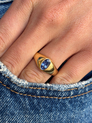 Antique Edwardian iris-blue sapphire gypsy engagement ring with an iris-blue sapphire centre stone in a traditional gypsy setting, worn on a hand.
