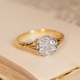 Antique Edwardian daisy cluster ring featuring old-cut diamonds arranged in a floral cluster with delicate yellow gold shoulders.