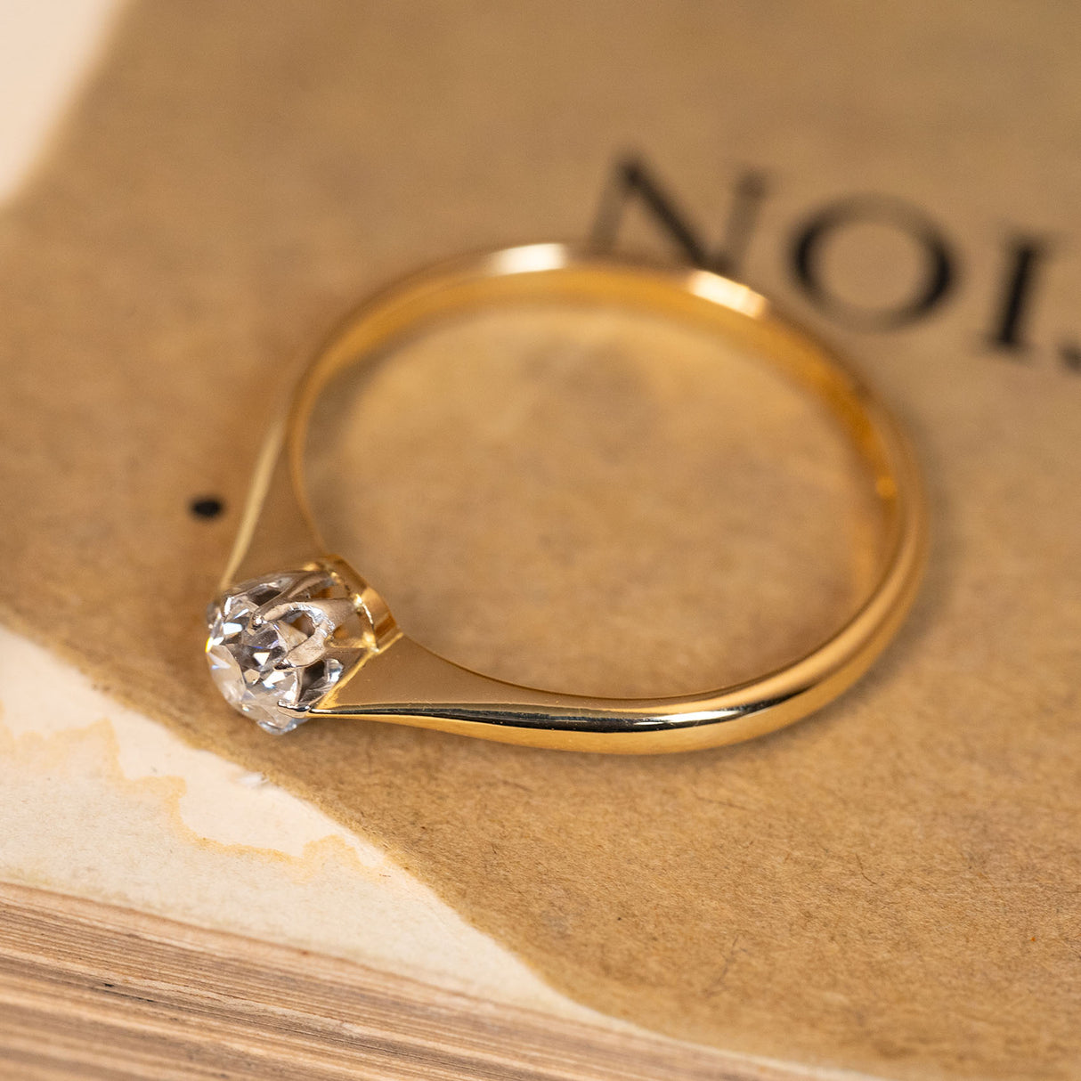Antique Edwardian old-cut diamond solitaire ring showcasing a bright old-cut diamond in a refined yellow gold and platinum setting.