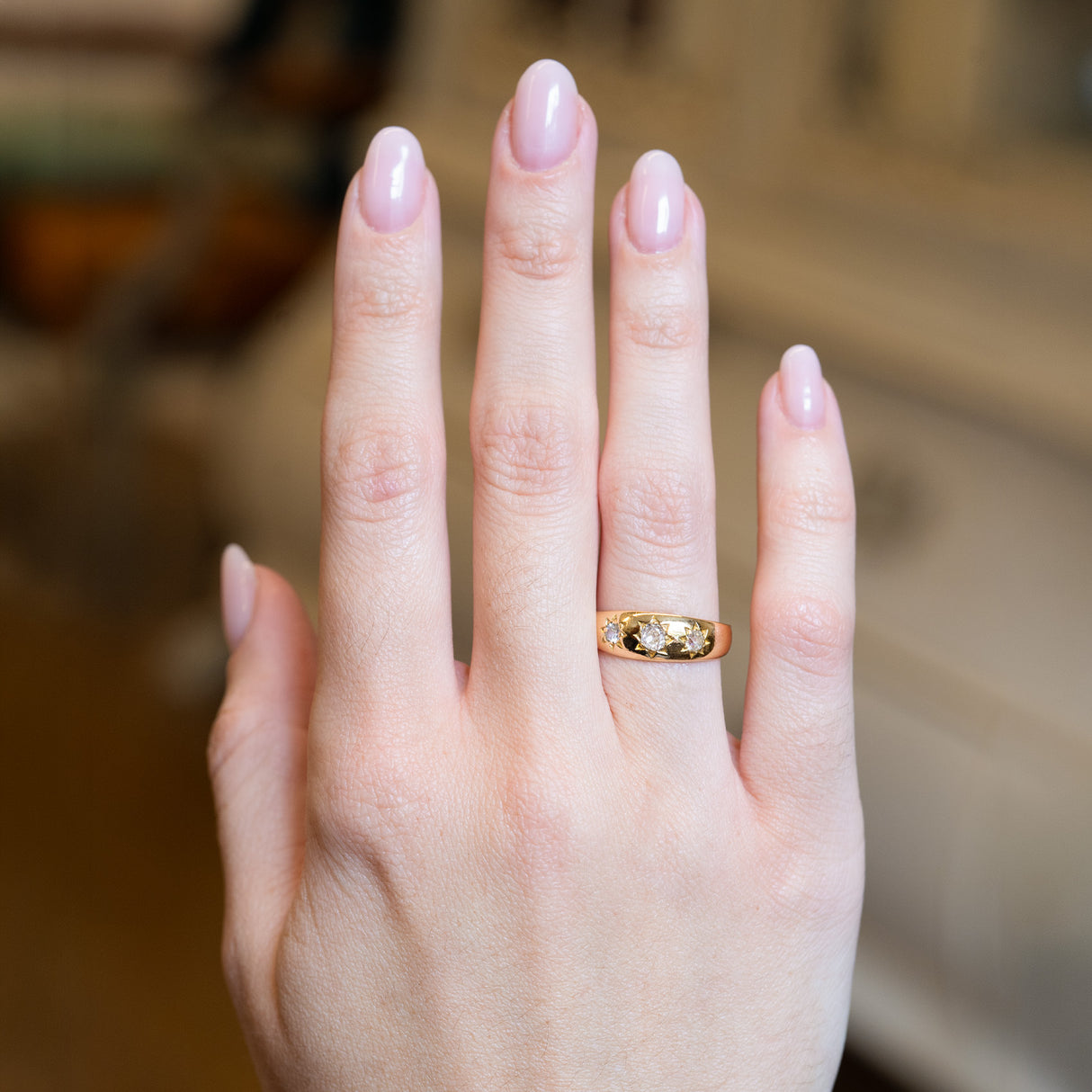Antique Edwardian old-mine cut diamond gypsy ring worn on hand.