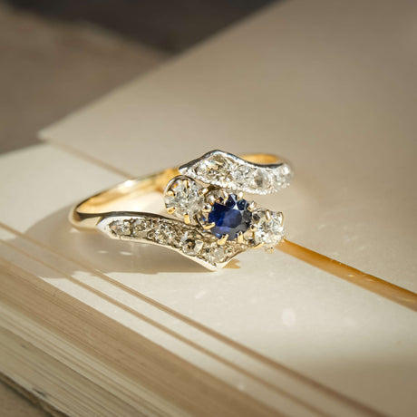 Antique Edwardian sapphire and diamond twist ring with blue gemstone and diamond accents