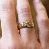 Close detail of antique Edwardian three-stone diamond gypsy ring with star-set diamonds.