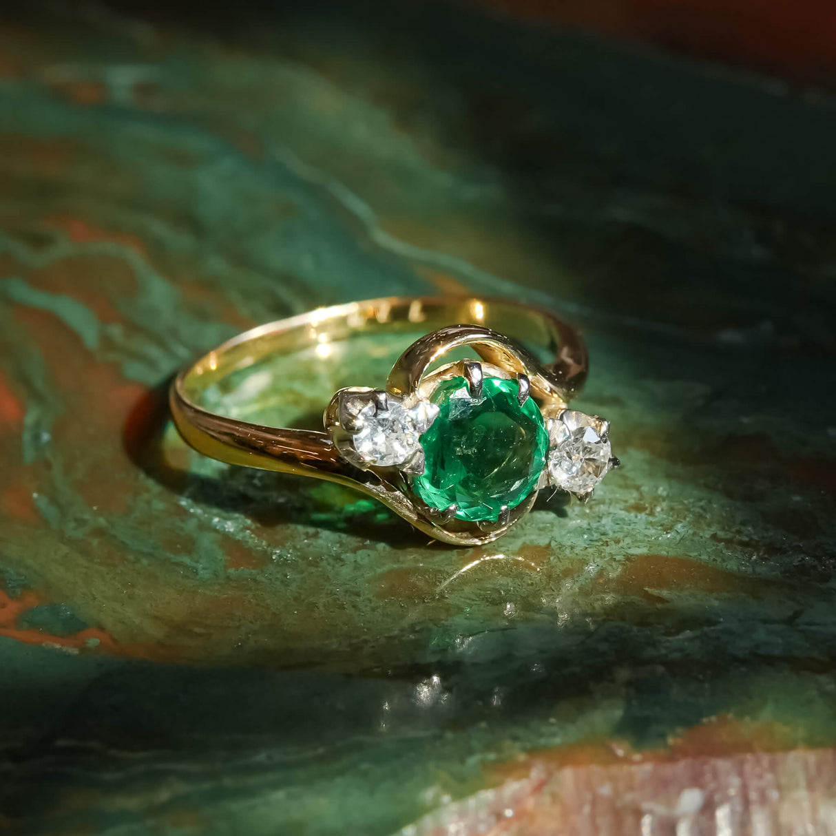 Antique emerald and diamond three stone ring with classic Edwardian design