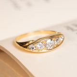 Antique Victorian old-mine cut diamond five-stone ring with graduated diamonds and a gently tapered yellow gold band.