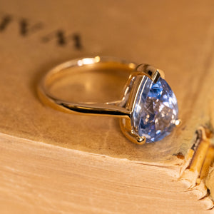 Pear-cut bluebell sapphire solitaire ring showcasing a luminous blue sapphire in an elegant yellow gold setting.