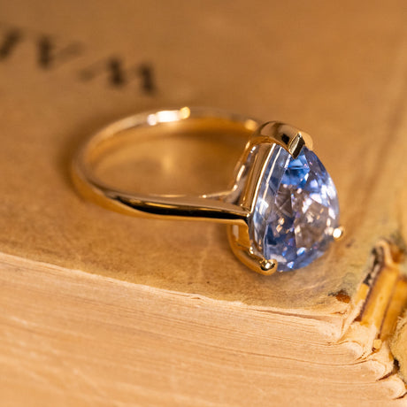Pear-cut bluebell sapphire solitaire ring showcasing a luminous blue sapphire in an elegant yellow gold setting.