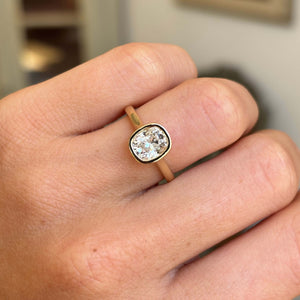 Antique-inspired cushion old-cut diamond solitaire engagement ring with a sparkling cushion old-cut diamond in a refined rub-over yellow gold setting