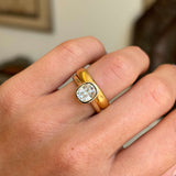 Antique-inspired cushion old-cut diamond solitaire engagement ring highlighting a cushion old-cut diamond and warm yellow gold wedding band