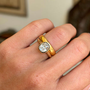 Antique-inspired cushion old-cut diamond solitaire engagement ring highlighting a cushion old-cut diamond and warm yellow gold wedding band