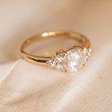 Antique inspired diamond trefoil cluster engagement ring showcasing a round brilliant-cut centre diamond with trefoil diamond shoulder details.