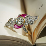Antique Art Nouveau ring with central diamond and ruby accents with diamond set design