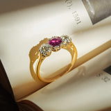 Antique ruby engagement ring with two diamonds in three stone setting