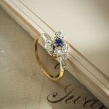 Antique Edwardian sapphire and diamond twist ring with blue gemstone in gold setting