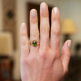 Green zircon ring worn on hand with natural manicure.