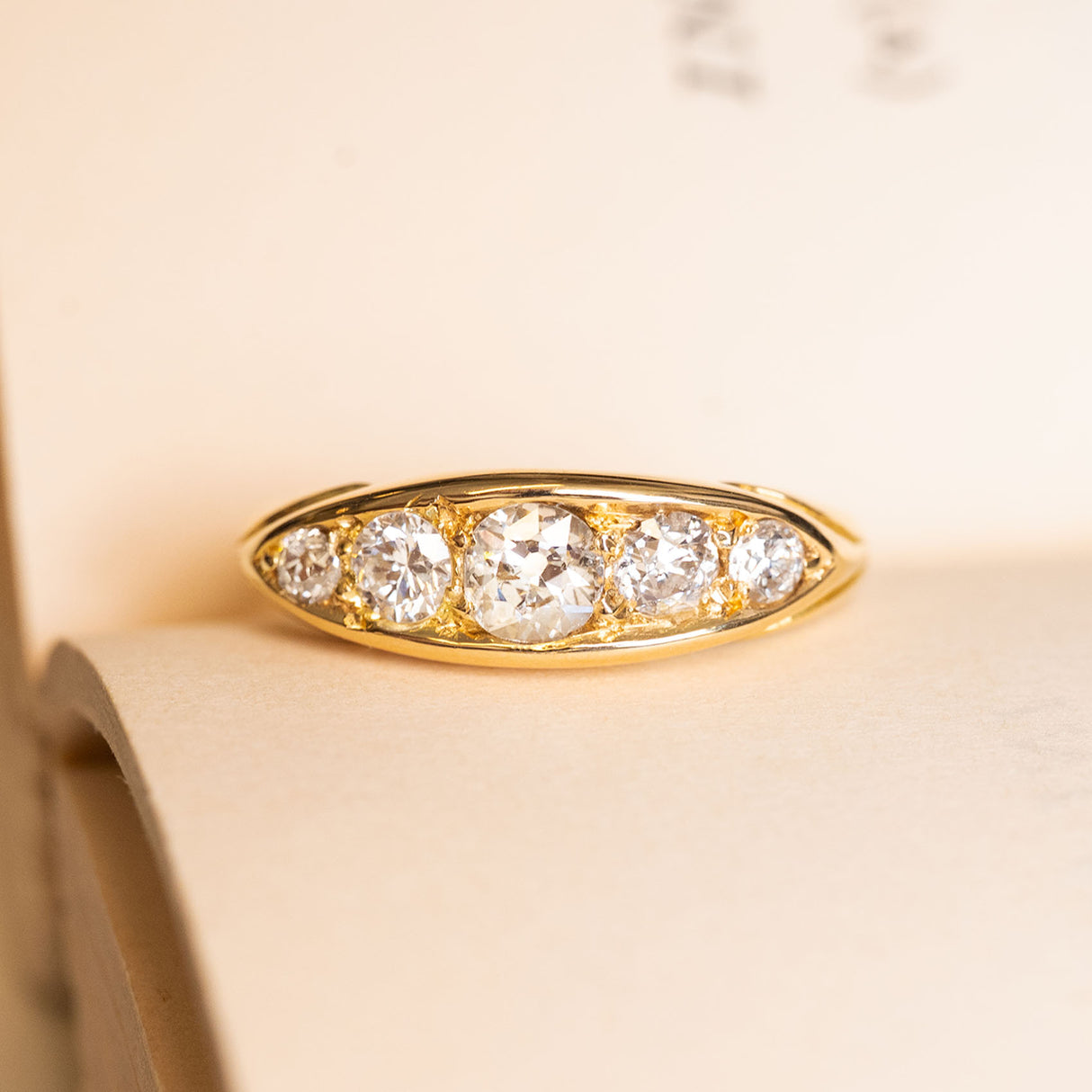 Antique Victorian old-mine cut diamond five-stone ring in yellow gold with graduated old-cut diamonds.