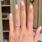 Antique Victorian old-mine diamond five-stone ring set with five graduated old-mine cut diamonds, displayed on a hand.