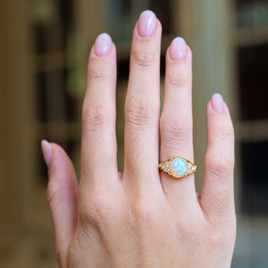 Antique Victorian opal and diamond ring worn on hand.