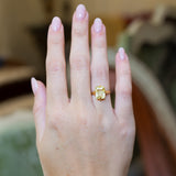 Antique Victorian yellow sapphire solitaire ring worn on hand.
