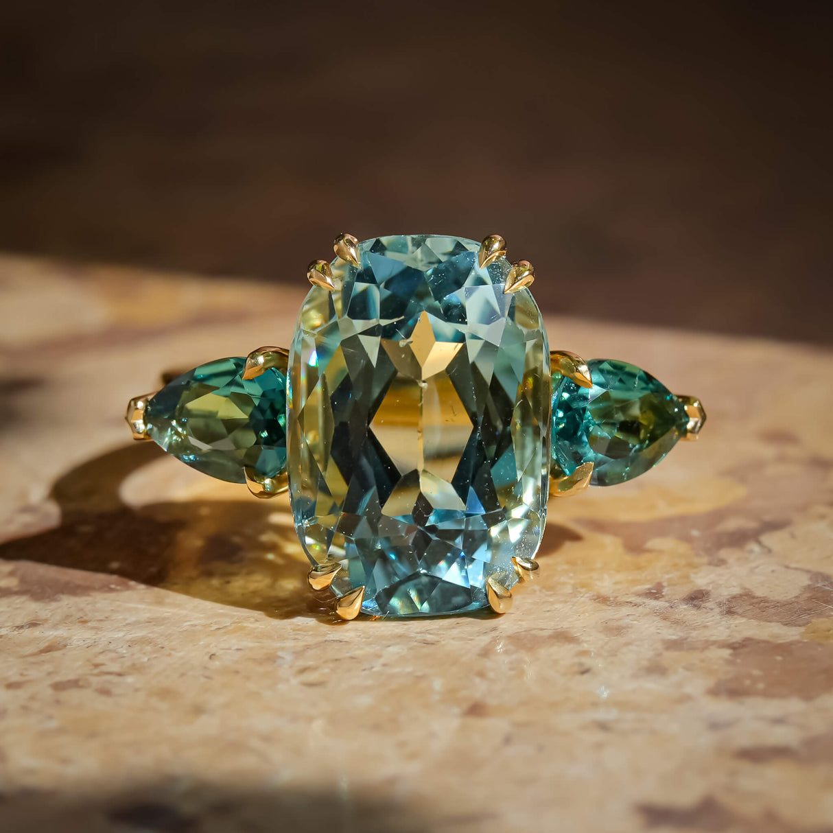 Aquamarine and sea green tourmaline three stone ring in gold setting