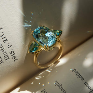 Aquamarine and sea green tourmaline ring with three stone design in gold