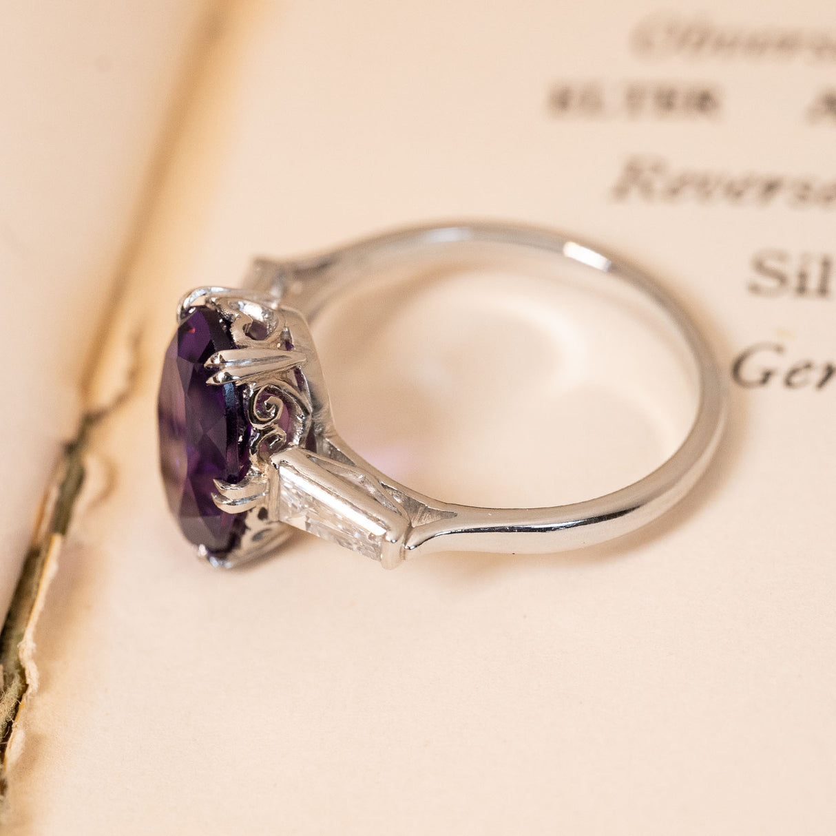 Art Deco amethyst and diamond ring with an oval-cut amethyst, tapered baguette diamonds and an intricate platinum gallery.