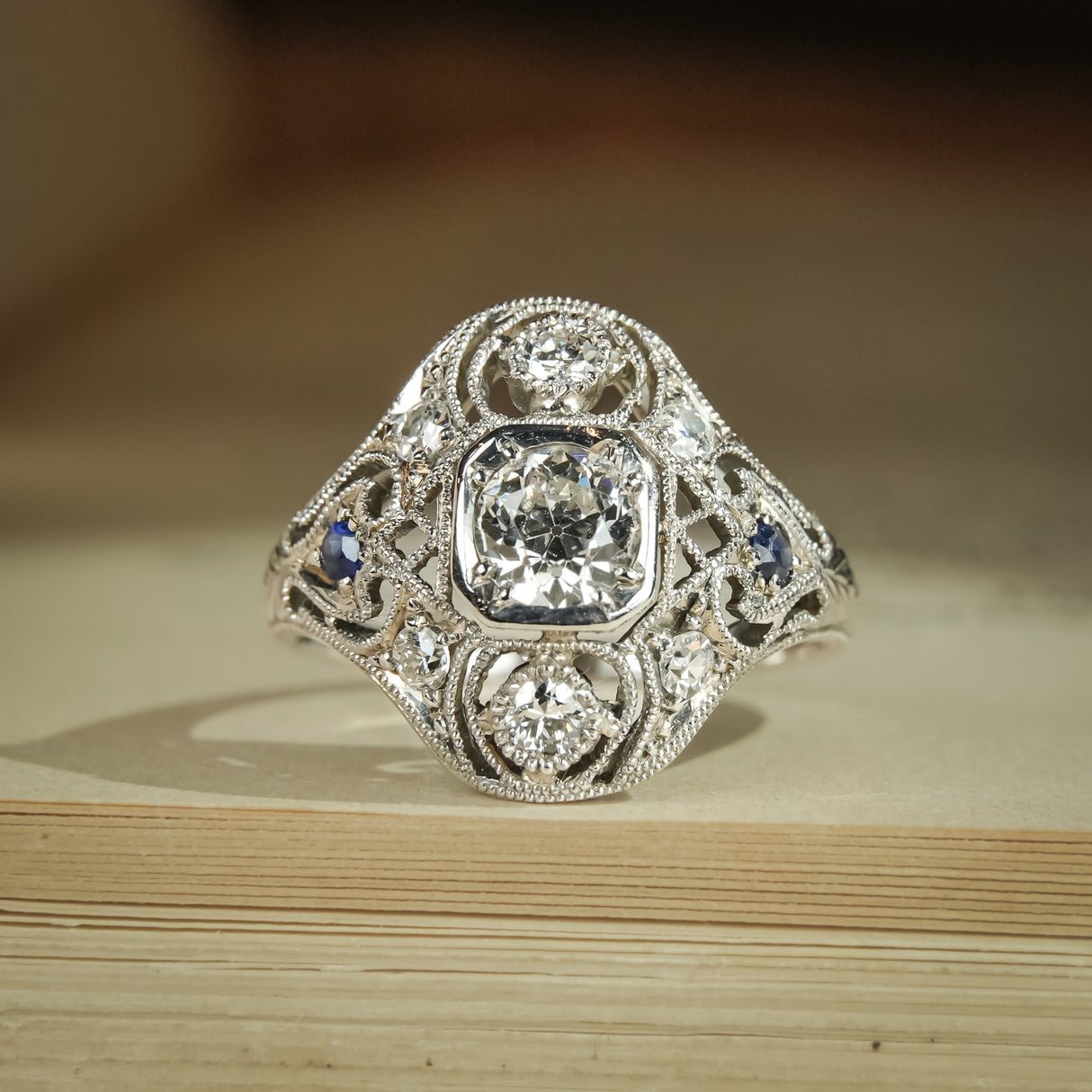 Art Deco antique diamond and sapphire cluster ring with milgrain detail