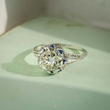 art deco diamond sapphire cluster ring with antique design in white gold