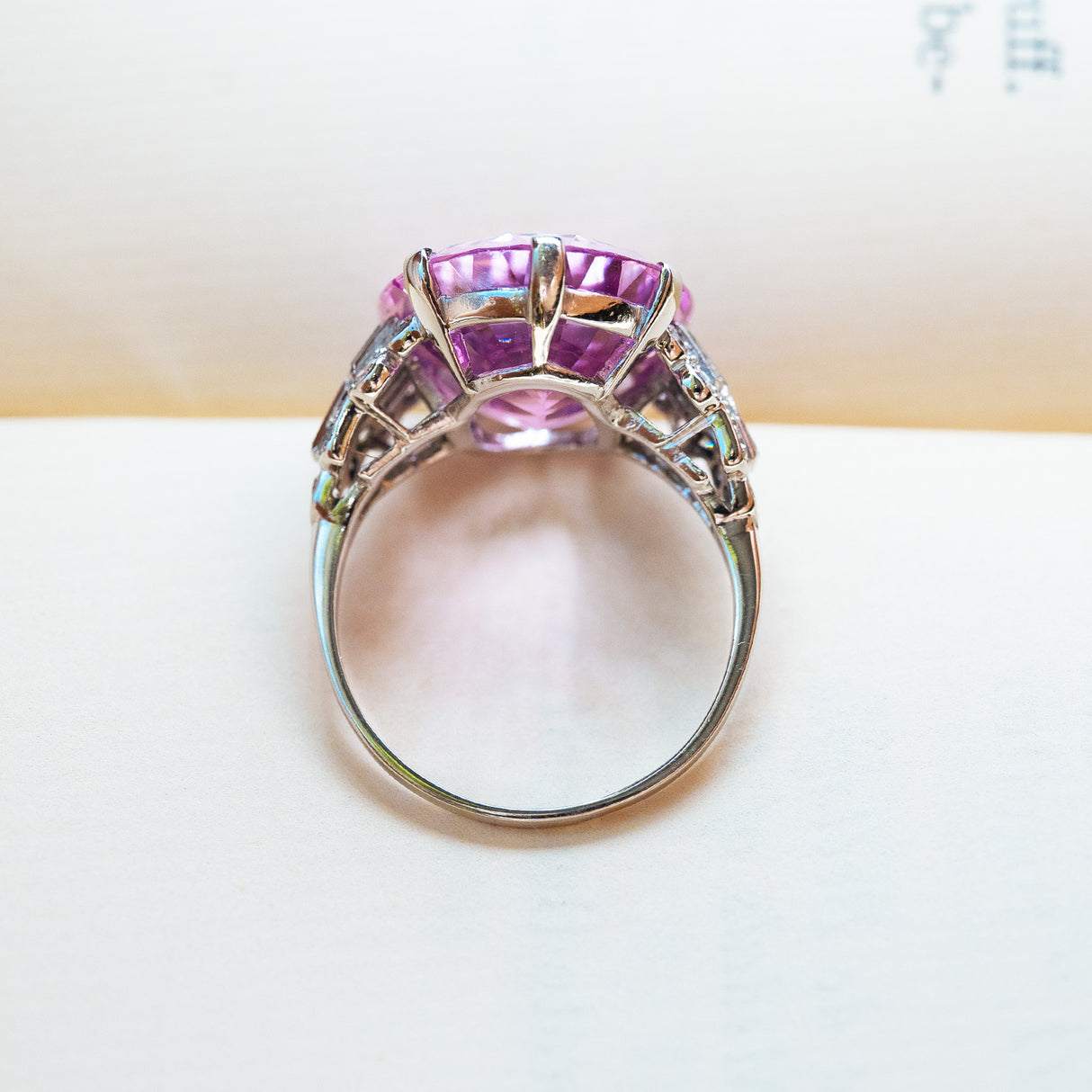 Art Deco pink topaz and diamond cocktail ring showing openwork setting and diamond detail.