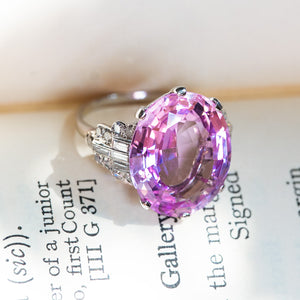 Art Deco pink topaz and diamond cocktail ring showing tapered diamond shoulders and setting detail.