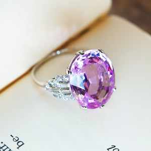 Art Deco pink topaz and diamond cocktail ring highlighting faceted pink topaz and diamond side stones.