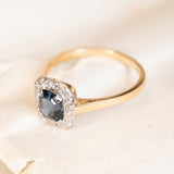 Antique Art Deco sapphire and diamond cluster ring featuring a deep blue sapphire framed by diamonds in yellow and white gold.