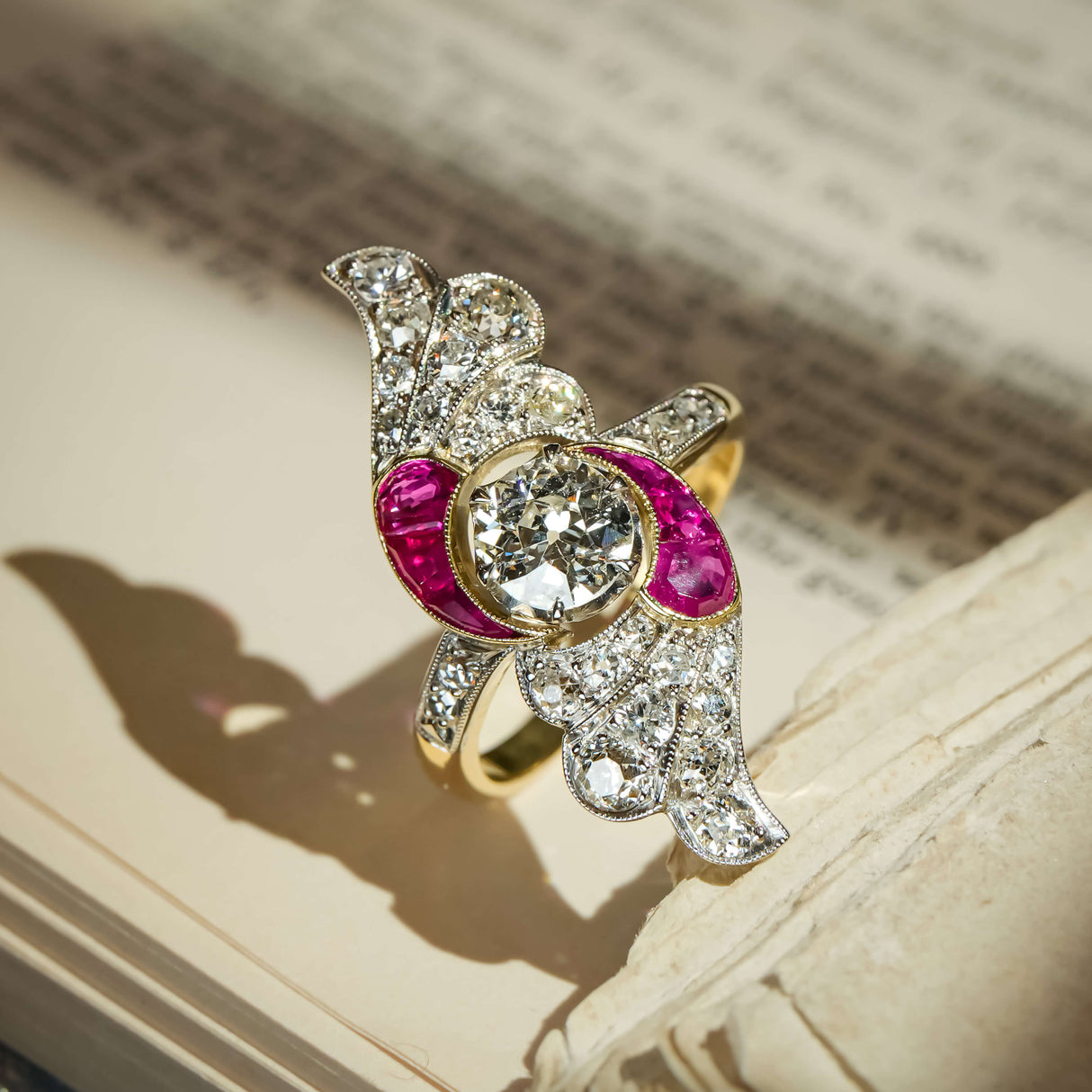 Art Nouveau diamond and ruby cocktail ring with central diamond and curved ruby accents