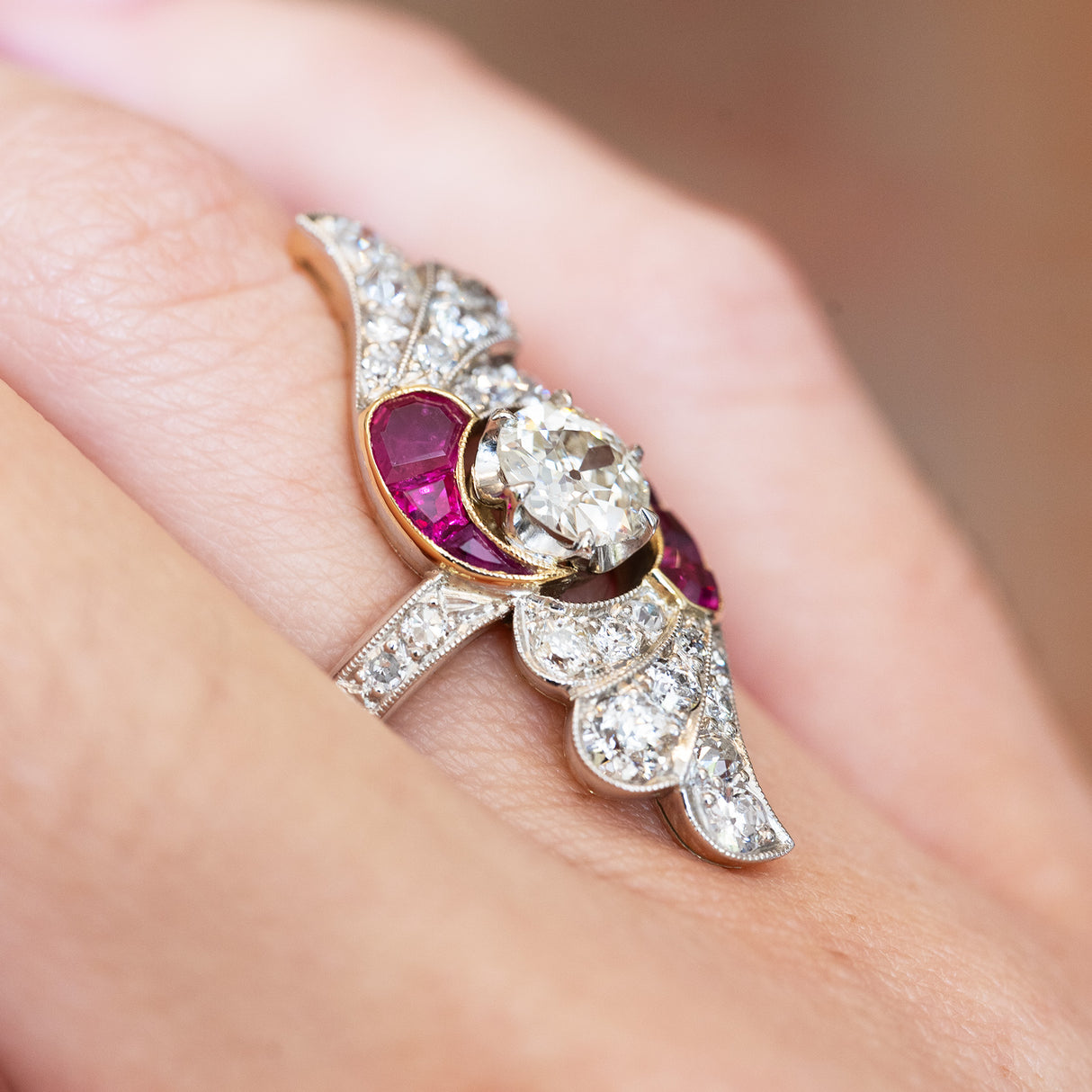 Ruby and diamond cocktail ring detail highlighting flowing setting and stone arrangement.
