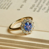 Oval-cut blue sapphire and diamond cluster engagement ring