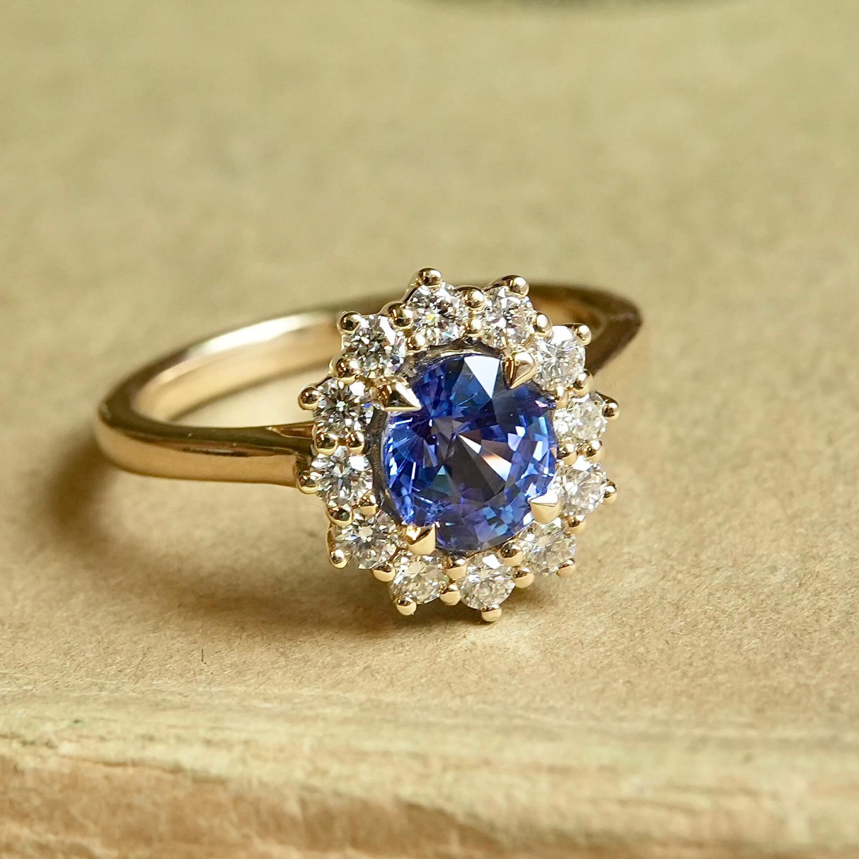 Oval-cut blue sapphire and diamond cluster engagement ring