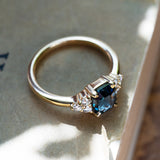 blue sapphire ring with diamond cluster and yellow gold band