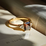 brown diamond three stone engagement ring with white diamond side stones in yellow gold