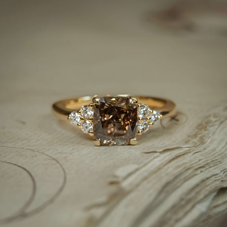Brown diamond three stone trefoil engagement ring with diamond side clusters