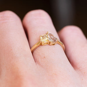 Brown and yellow diamond Toi et Moi engagement ring with gold setting and contrasting diamond shapes.