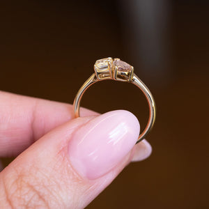 Brown and yellow diamond Toi et Moi engagement ring showing open gold gallery and dual-stone setting.