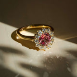 burnt orange sapphire cluster engagement ring with diamond halo in yellow gold