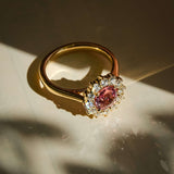 burnt orange sapphire and diamond cluster engagement ring in yellow gold with halo
