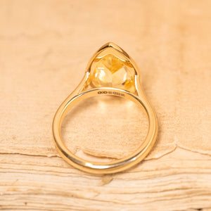 Yellow gold solitaire ring showcasing a canary yellow pear-cut sapphire with clean, contemporary styling.