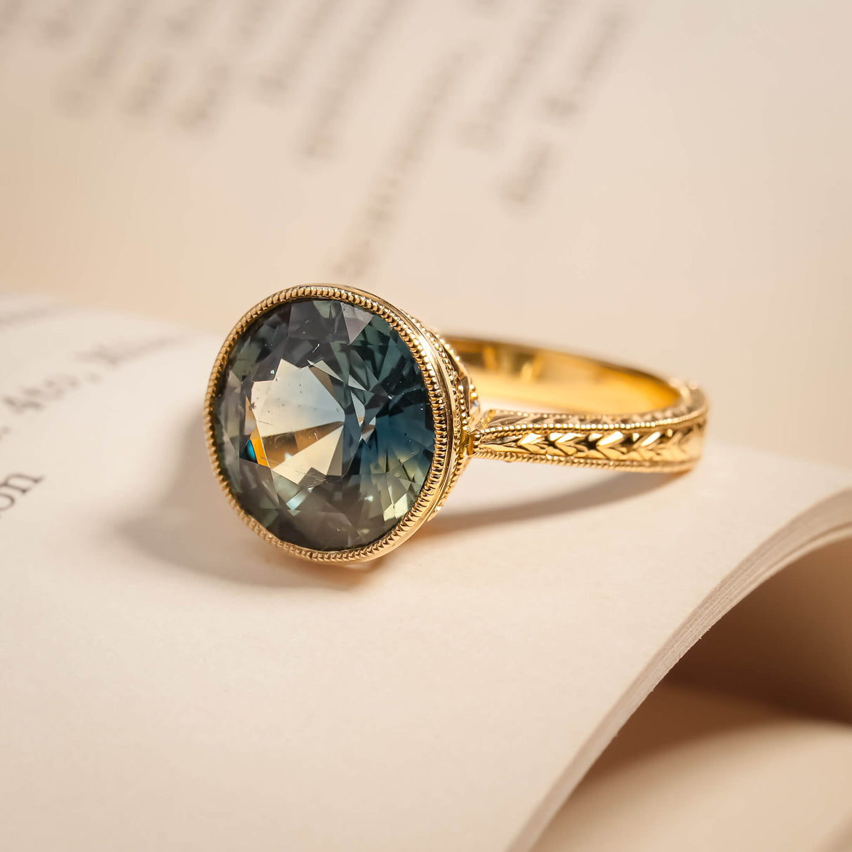 Caribbean blue green sapphire solitaire ring with engraved gold band