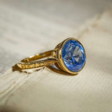 Ceylon sapphire solitaire ring with cornflower blue round gemstone and gold band