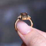 Chocolate brown diamond cluster tre-foil engagement ring showing raised gold setting and diamond accents.