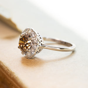 Vintage cinnamon brown diamond cluster ring with round brown diamond surrounded by brilliant-cut diamonds.