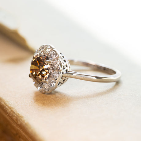 Vintage cinnamon brown diamond cluster ring with round brown diamond surrounded by brilliant-cut diamonds.